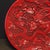 This exquisite decorative plate features a deep, vibrant red finish with intricate, high-relief carving characteristic of...