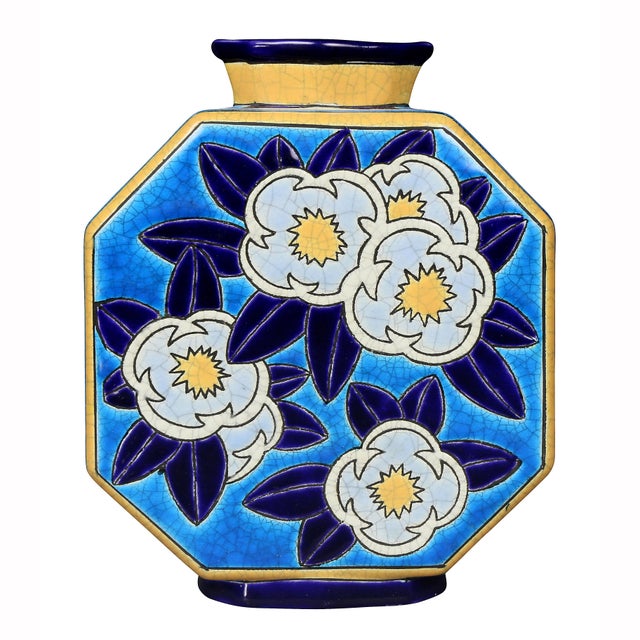 Octagonal flask form decorated in light and dark blue, yellows and white.