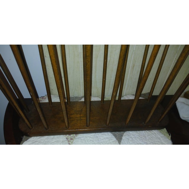 Vintage mid-century modern magazine rack designed in the style of Arthur Umanoff. It features an oval-shaped frame with...