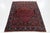 This Antique Bidjar Persian wool rug has a red and navy blue field with an all-over design in multicolor. This rug...