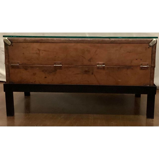 This large early 20th C traveling trunk is fashioned in leather and has brass corner protectors. It has been well used. We...