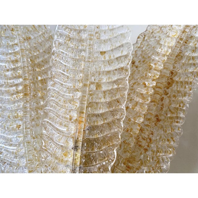 Contemporary luxury wall sconces in gold metal frame with three levels of "leaves" in murano glass and amber graniglia....