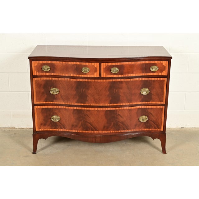 A gorgeous antique Georgian or Federal style serpentine front four-drawer dresser or chest of drawers In the manner of...