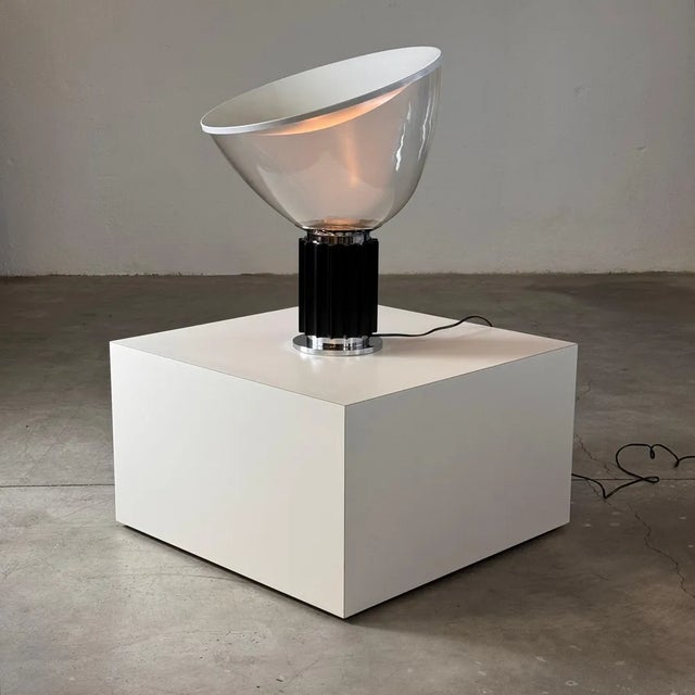 An iconic piece of Italian design, this Taccia table lamp by Achille and Pier Giacomo Castiglioni for Flos is from an...