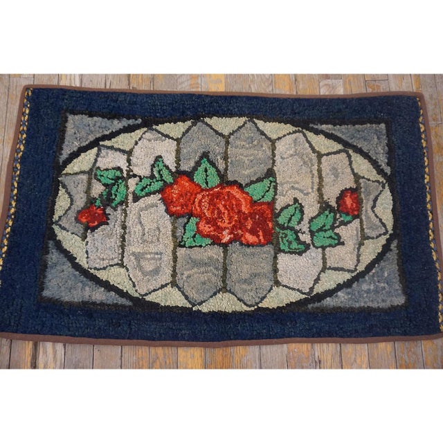 Antique American Hooked Blue 1890s Rug, Circa Date: 1890s. This charming example of an American hooked rug showcases the...