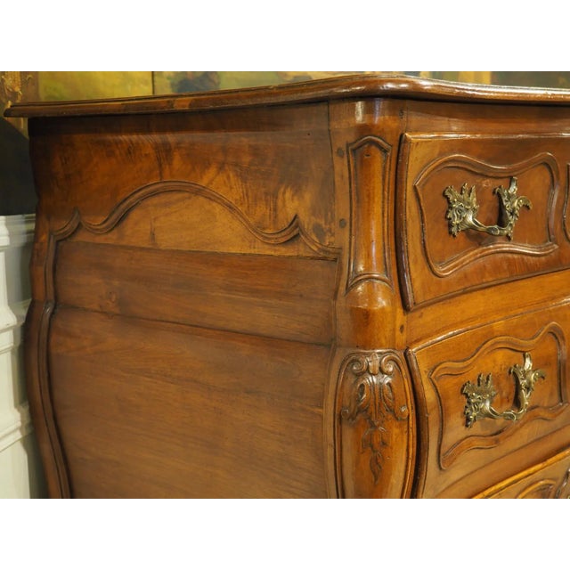 More information coming soon… The subtle bombe form does not detract from the masterfully carved moldings of this walnut...