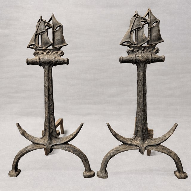 Pair of Bradley & Hubbard fireplace andirons; signature unavailable. 1920s. Naval motifs: ship and anchor. Wrought iron....