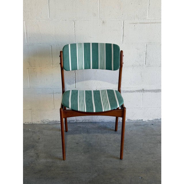 In style of Erik Buch Model 49 dining chair features a sculpted frame with organic curves and an elegant floating seat...