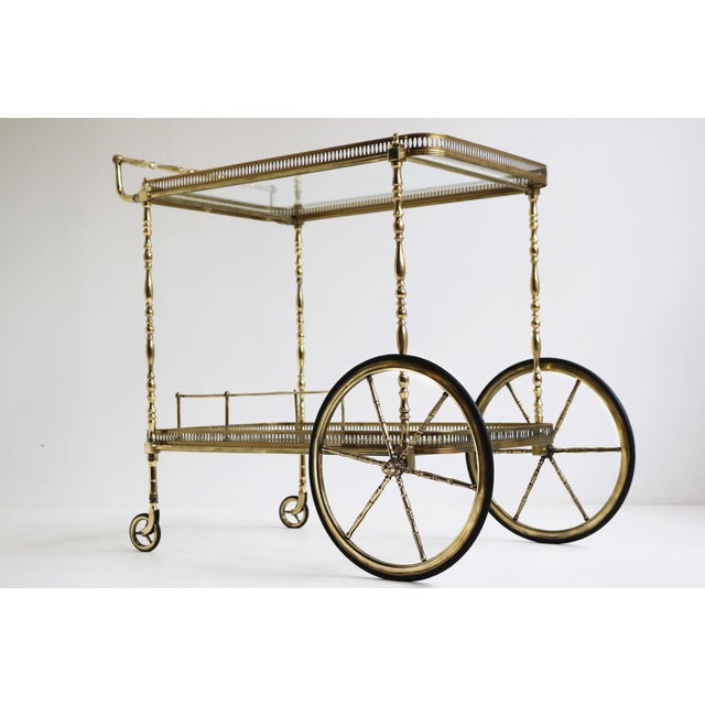 Gorgeous full brass neoclassical bar cart / serving trolley designed by Maison Bagues in 1940. An exquisite quality piece,...