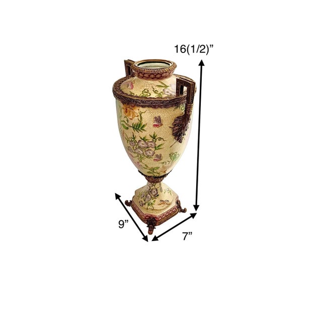 A striking pair of chinoiserie porcelain vases with metal accents and a lush botanical floral design — at 16.5 inches...