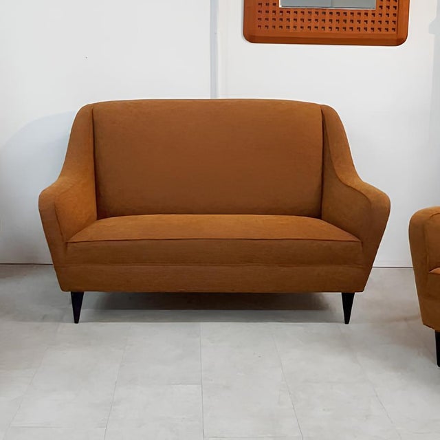 Elevate your living space with this charming living room set consisting of a two-seater sofa and two matching armchairs, a...