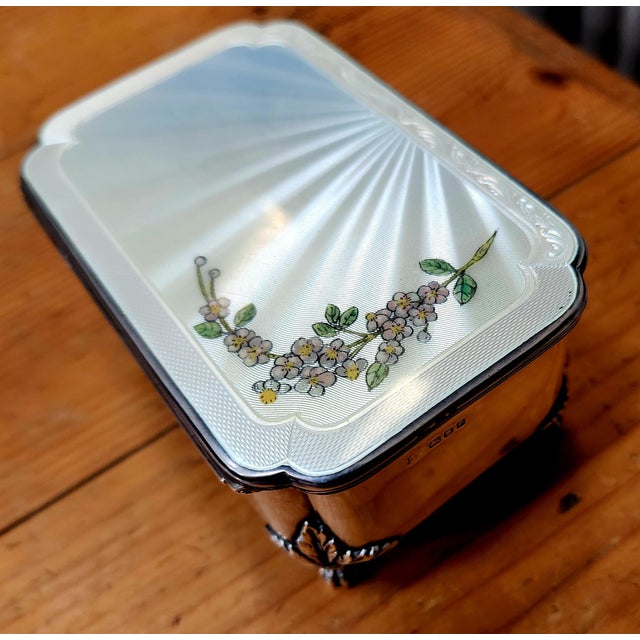 Beautiful antique jewelry box: On the top is a lovely guilloche enamel of flowers, on a brilliant white background. Set in...