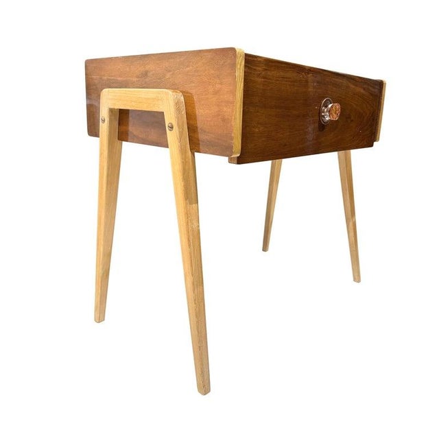 A Mid-Century Modern Side Table or Lamp table constructed of two different colors of teak, a drop-down drawer, with a...