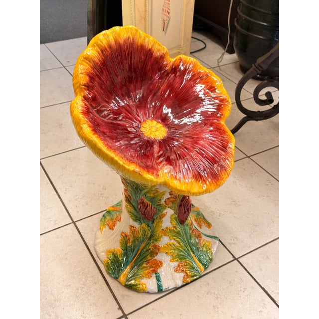 A whimsical and vibrant ceramic chair from Italy, sculpted in the dramatic form of a fully bloomed poppy flower. The wide,...