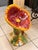 A whimsical and vibrant ceramic chair from Italy, sculpted in the dramatic form of a fully bloomed poppy flower. The wide,...