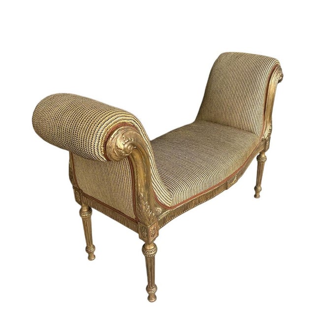 An elegant English giltwood window seat, possibly dating to the 18th century, crafted with refined proportions and gently...