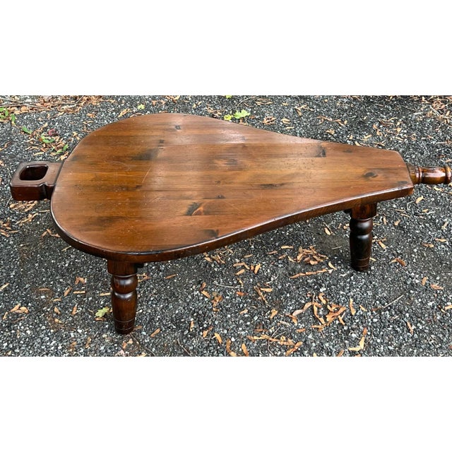 Great vintage bellows shaped pine coffee table. Thick chunky farmhouse style with three turned legs. Lots of character...