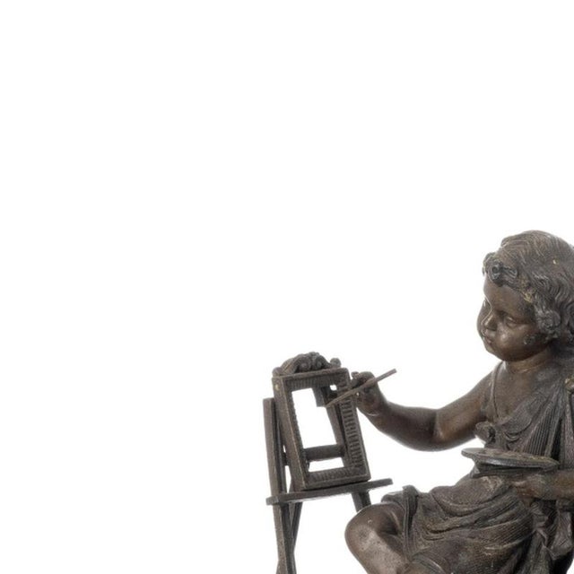 Table clock - 19th century. French, 19th century; made of antimony with a boy painted on it. Dimensions: 33 cm x 38 cm.