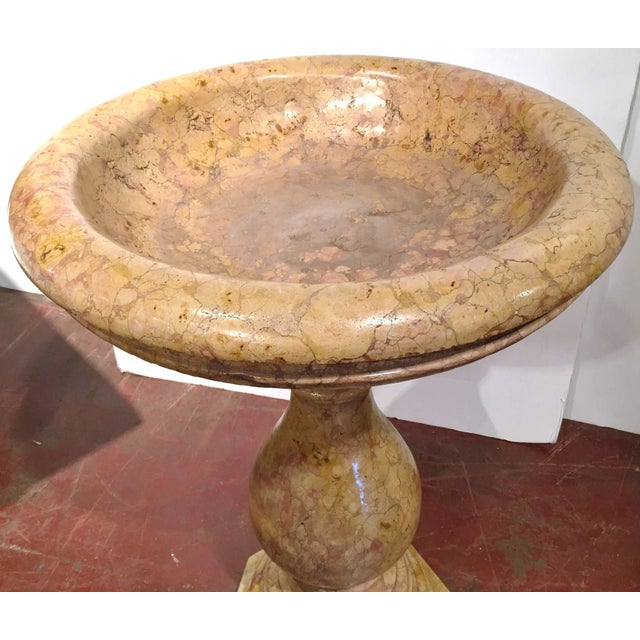 This large antique two-piece marble stand with a bowl, crafted in Italy circa 1920, showcases a timeless classical Roman...