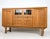Oak sideboard with carved linenfold-style panels to the cabinet doors and drawers, raised on turned legs. The case...
