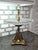 An exquisite vintage decorative fruit stand featuring an intricately detailed brass pedestal base adorned with four...