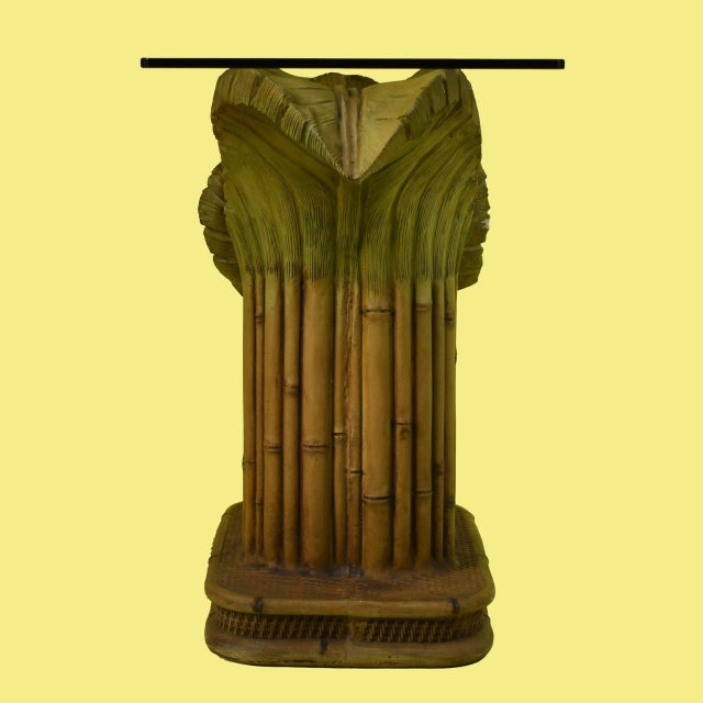 A sculptural vintage console in the manner of Serge Roche, with a dramatic carved palm-leaf base supporting a clear glass...