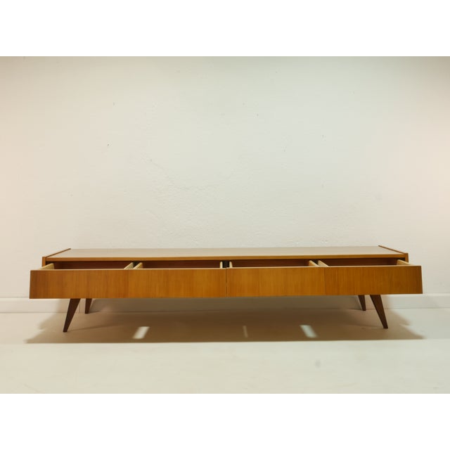 An exceptionally elegant vintage lowboard from the 1960s with clean lines and typical Mid-Century Modern design. This...