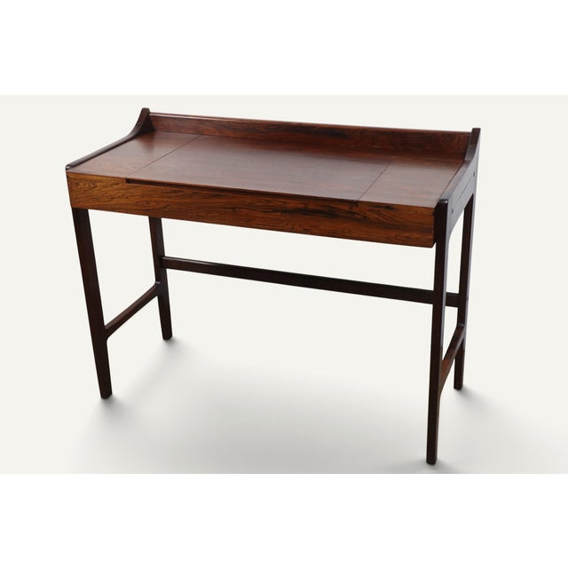 An elegant Danish dressing table/desk from the 1960s, representative of the meticulous craftsmanship of Scandinavian...