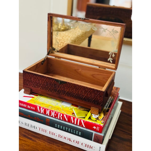 The perfect place to hide all of your treasures. This is a vintage hand carved wooden box. It is footed with an etched...