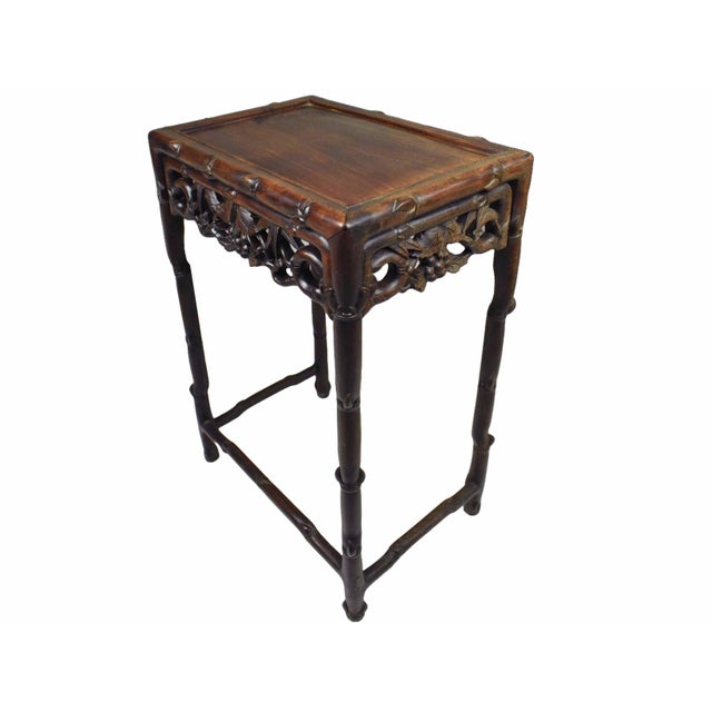 This exquisite side table is a masterful example of late 19th or early 20th-century Chinese craftsmanship, featuring an...
