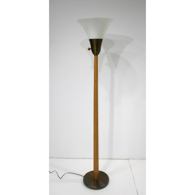 A Mid Century floor lamp with milk glass funnel shade , combed oak staff and matching round ball switch with spun brass...