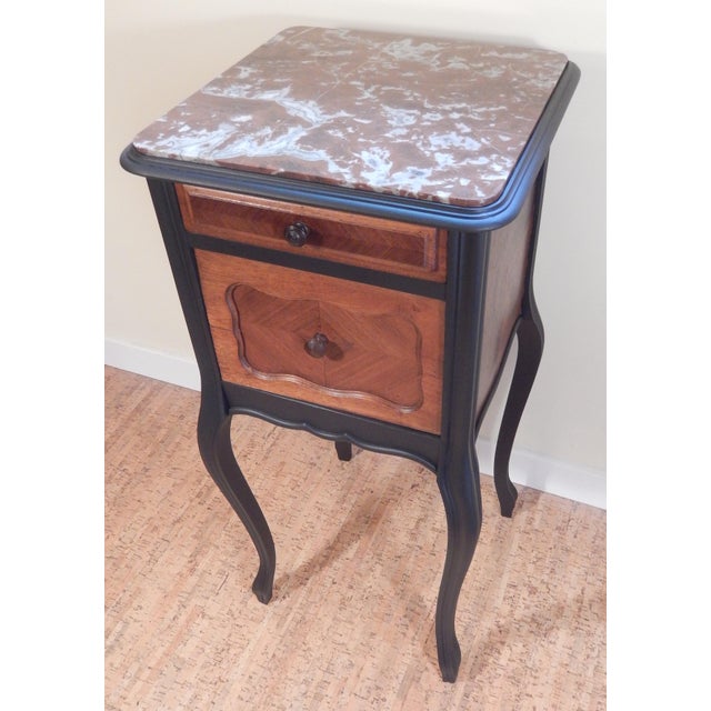Exceptional French table from the early 1900's that has been hand-crafted from heirloom grade mahogany and French walnut...