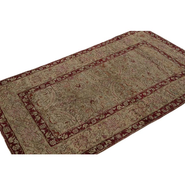 Hand-knotted in wool, circa 1880-1890, originating from India, this 4x6 Antique Agra rug features dense floral patterns in...