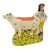 This Staffordshire cow and boy figurine is a substantial English Staffordshire-style earthenware flatback with the warmth...