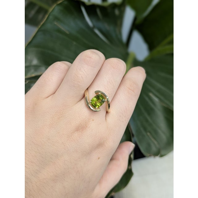 Pure, modern, and radiant — this 2.13 carat cushion-cut Arizona peridot ring offers a fresh take on the solitaire. The...