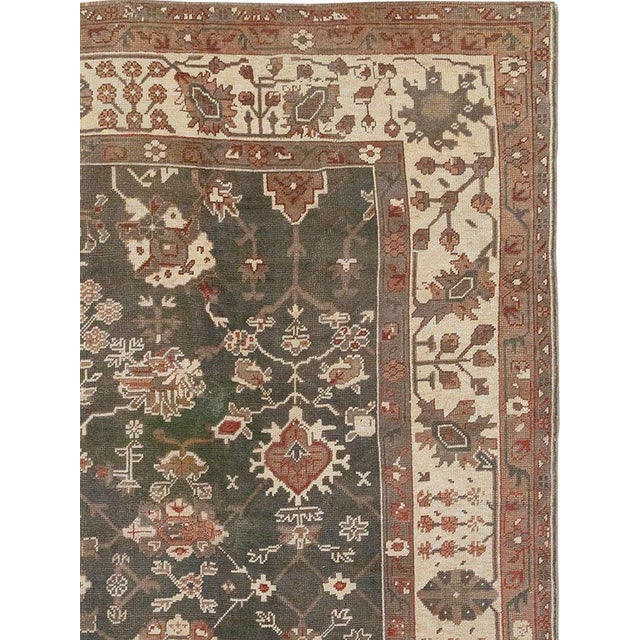 An antique Turkish Oushak room size carpet. Clearly in the Persian design mode, this west Turkish workshop carpet displays...