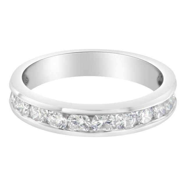 This diamond semi-eternity band features a row of brilliant cut round diamonds channel set in an 18 karat white gold band....