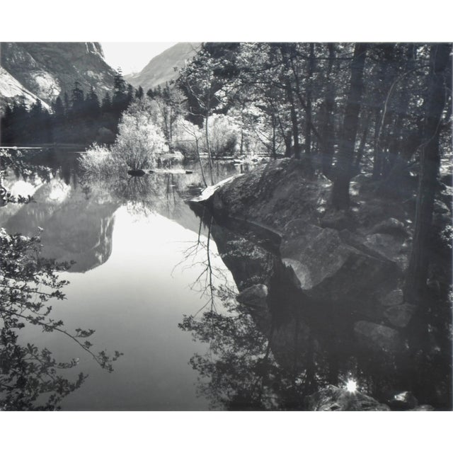 Stunning black & white landscape photograph with trees reflecting in water in the Sierra Nevada mountains by California...