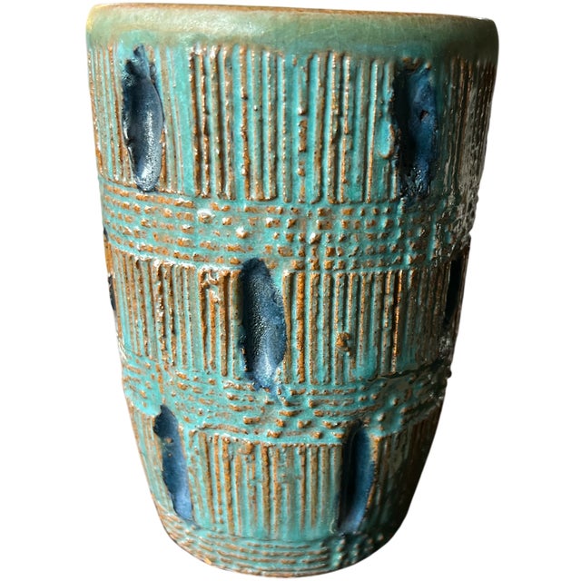 A striking mid-century studio pottery vase featuring deeply carved vertical striations and woven band detailing, finished...