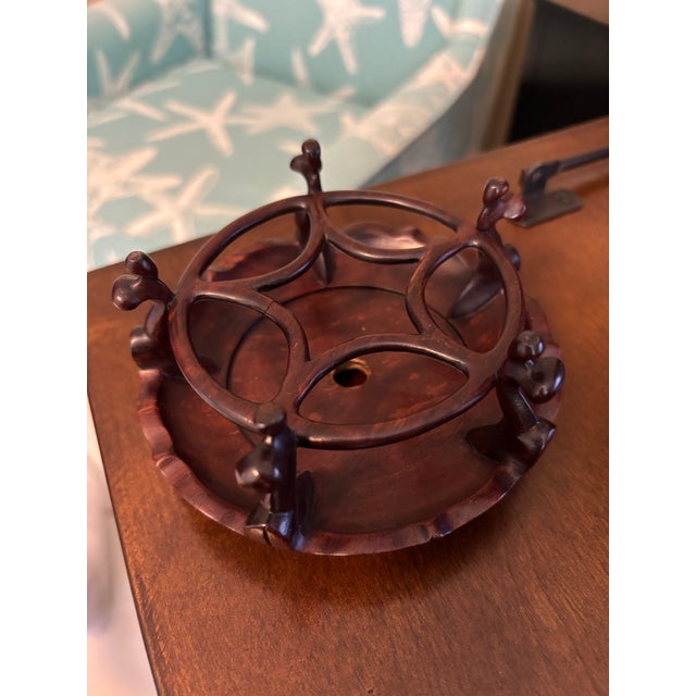 Vintage Chinese carved hardwood display stand featuring an elegant openwork gallery, stylized curled feet, and carved...
