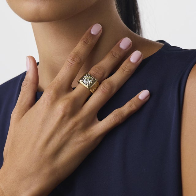 This striking vintage diamond ring is a bold 1970’s design, centered by a GIA-certified round brilliant cut diamond...