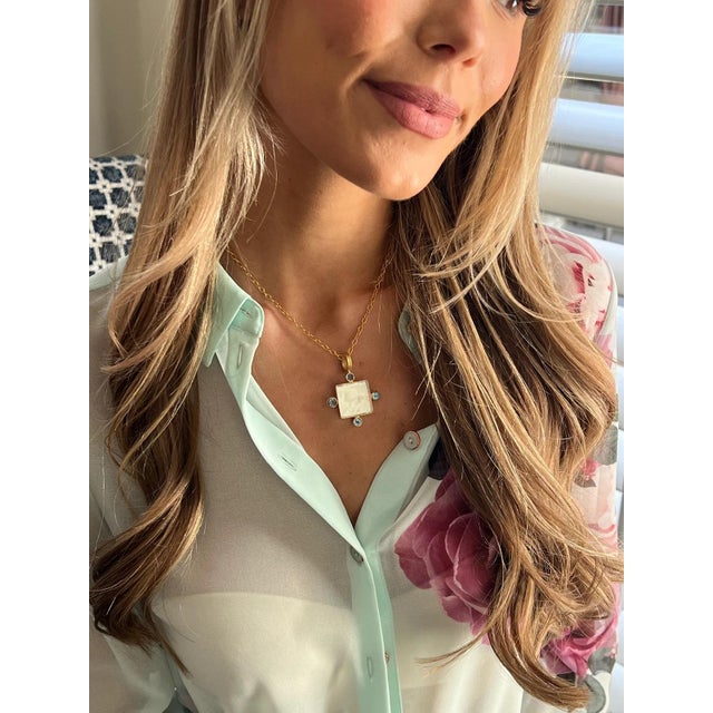 This lightweight Equestrian Intaglio necklace includes blue topaz accents. 18”