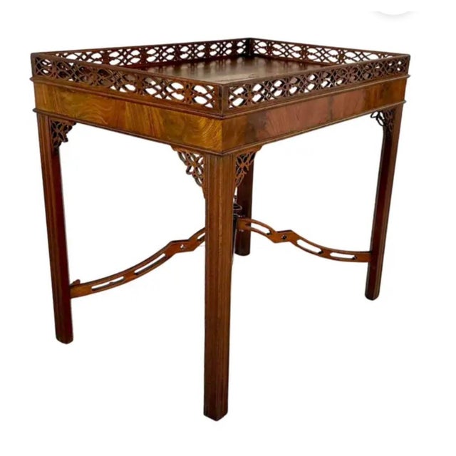 George III Chippendale Carved Mahogany Silver Table. Table features a fixed tray top with an intricately pierced gallery...