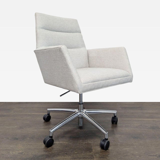 This Room & Board office chair offers modern style and everyday comfort. It features a light gray upholstered seat and...