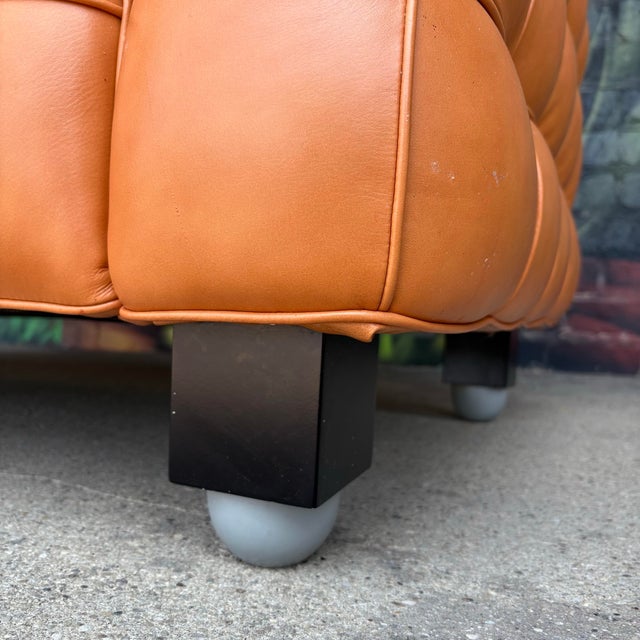 Orange leather tufted sofa or loveseat designed by Josef Hoffmann. The Kubus sofa is an extraordinary example of...