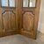 A striking antique French four-panel folding screen crafted in solid walnut with an elegant arched silhouette, glazed...