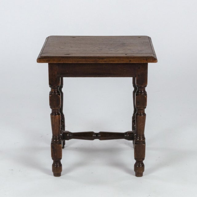 English oak square stool with turned legs and H-stretcher, circa 1890. height: 15 in. 38 cm., width: 14 in. 35.5 cm.,...