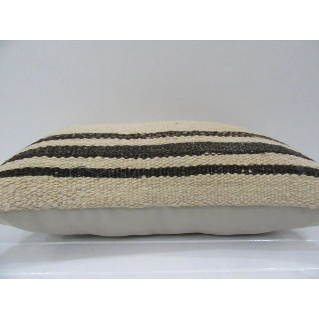 This is a pillow cover made from a vintage kilim rug. The piece was properly washed and ready to use. Pillow inserts not...