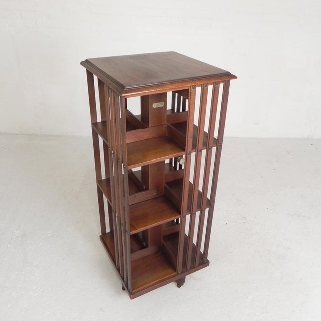 This carousel rotates smoothly. The bottom 2 tiers have dividers that can be folded up to accommodate larger books....