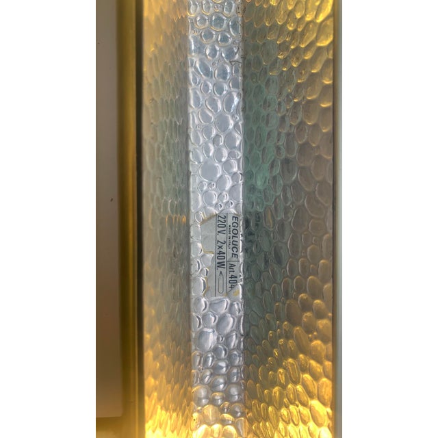 Pair of classic/modern style brass wall lights, designed for lighting paintings or mirrors. The main body consists of a...